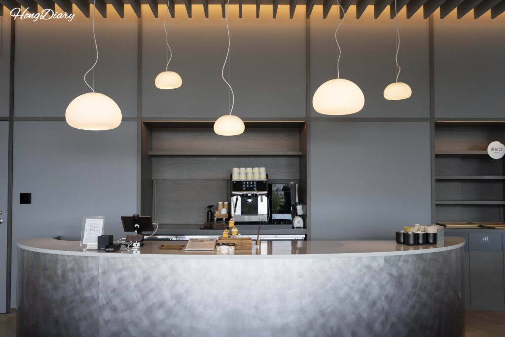 Cafe counter inside RISONARE Shimonoseki serving coffee, bakery items, gelato, and regional drinks