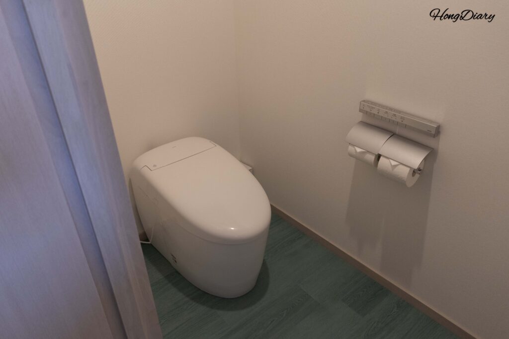 Separated toilet room with bidet-equipped seat at RISONARE Shimonoseki, independent from the bathroom area
