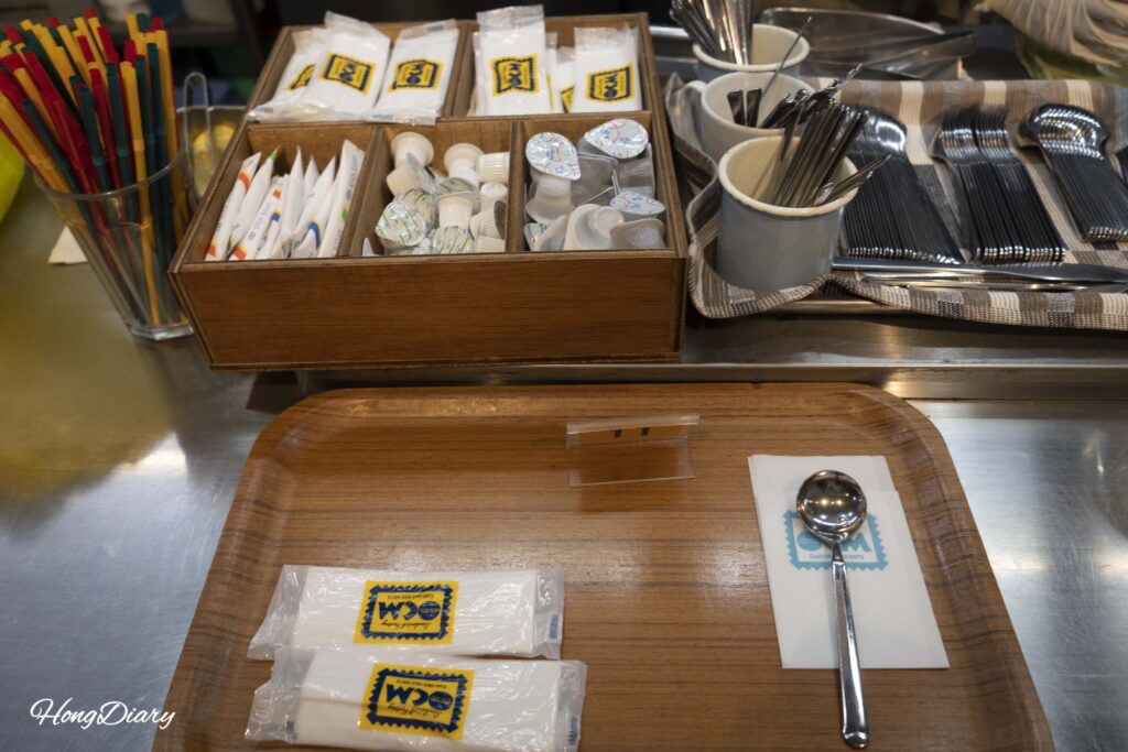 Dine-in tray at Sandwich Factory OCM with a spoon for soup, napkins, and tissues ready for a sit-down meal