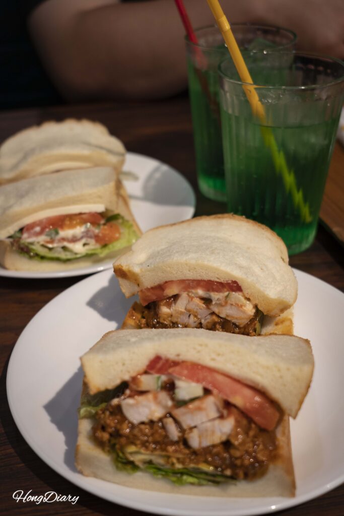 Full lunch order at Sandwich Factory OCM showing two sandwiches and melon soda drinks on a tray