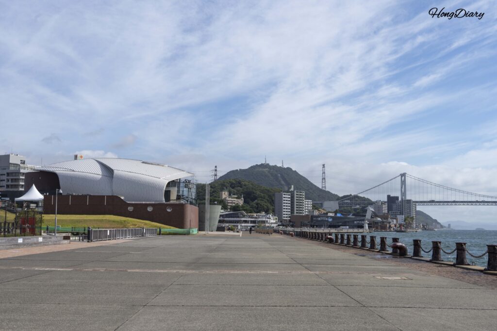 Panoramic view from Haikara't Yokocho showing Kaikyokan aquarium, Karato Market area, Kanmon Strait, and Kanmon Bridge in Shimonoseki
